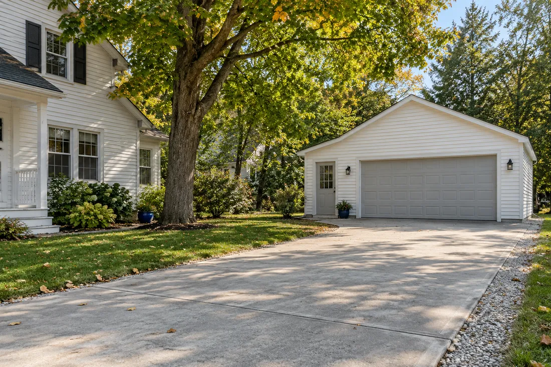 Representative quiet Ohio house with a broad driveway and detached residential garage.